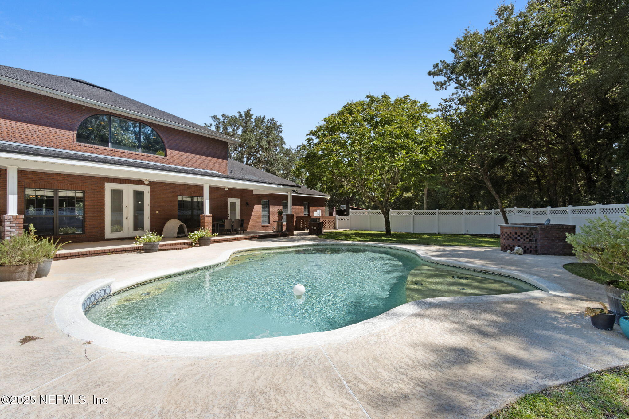 87377 Raddin Road Yulee, FL 32097 - Photo 2 of 75 a view of a house with swimming pool and a yard