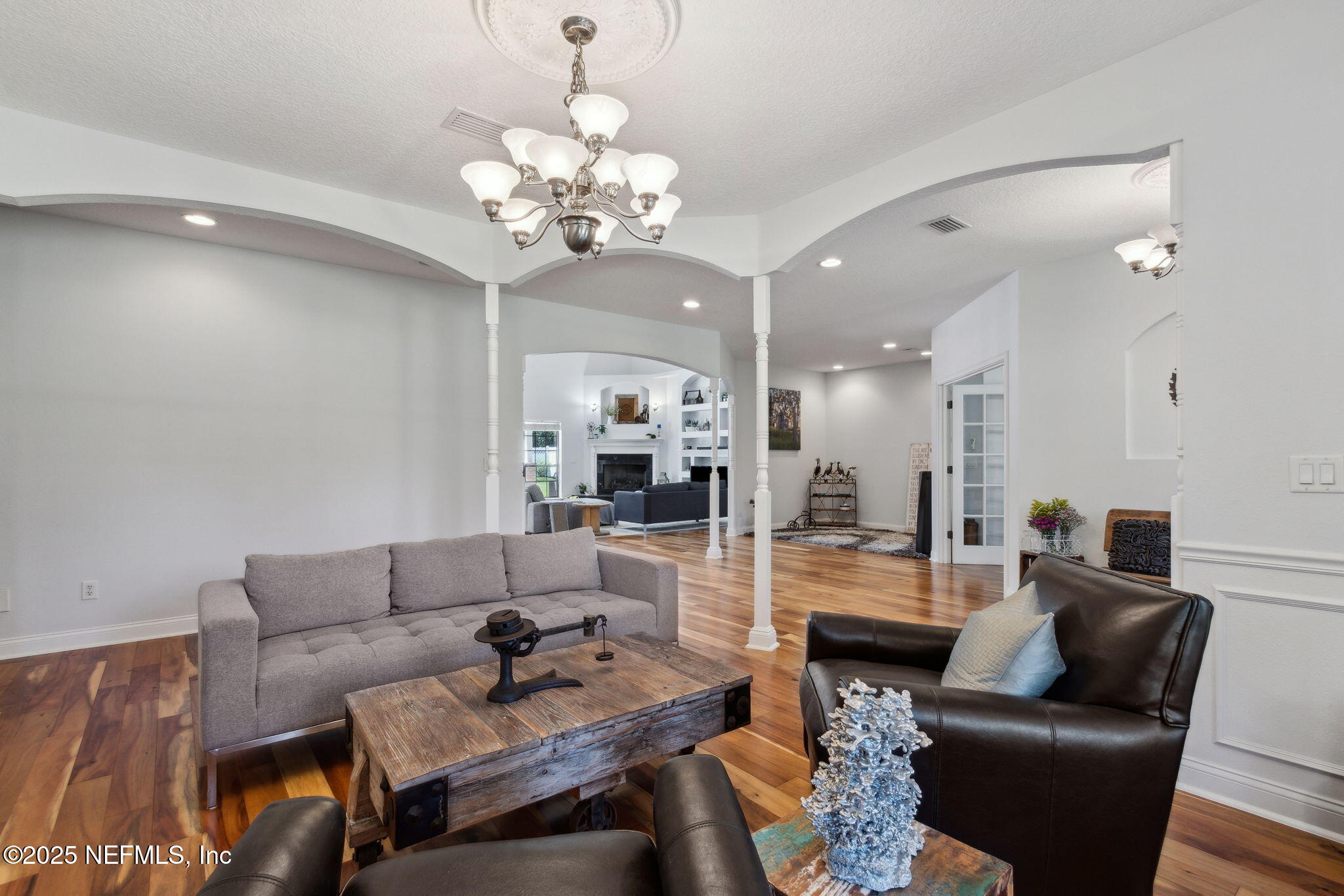 87377 Raddin Road Yulee, FL 32097 - Photo 21 of 75 a living room with furniture kitchen view and a chandelier