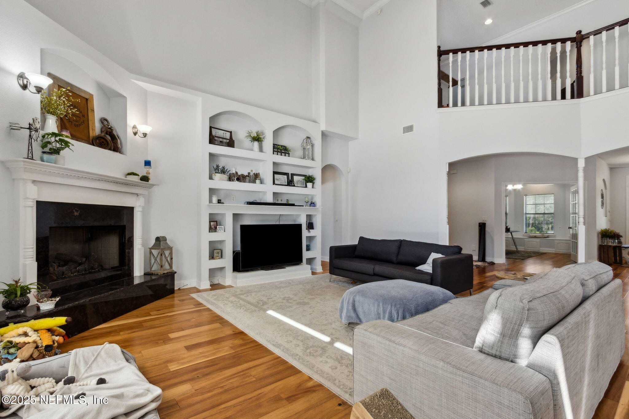 87377 Raddin Road Yulee, FL 32097 - Photo 24 of 75 a living room with furniture a flat screen tv and a fireplace