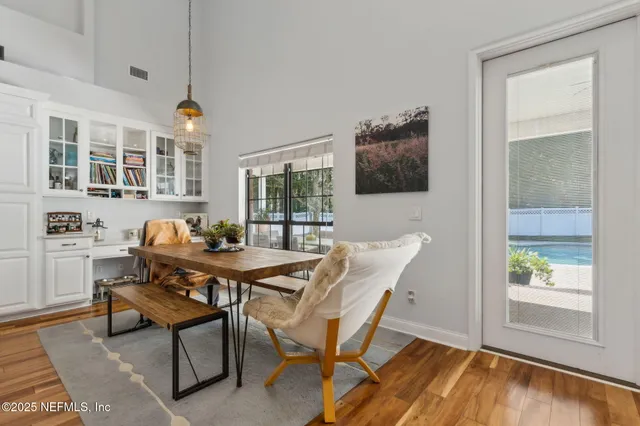 a view of a hallway with wooden floor and a window