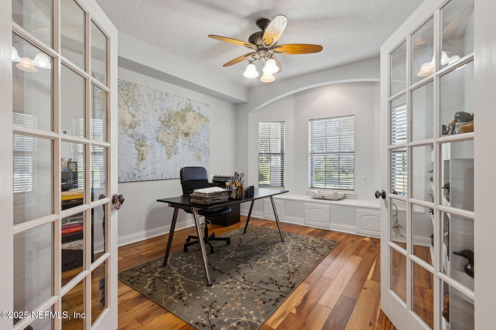 87377 Raddin Road Yulee, FL 32097 - Photo 36 of 75 a work room with furniture a large window and a chandelier
