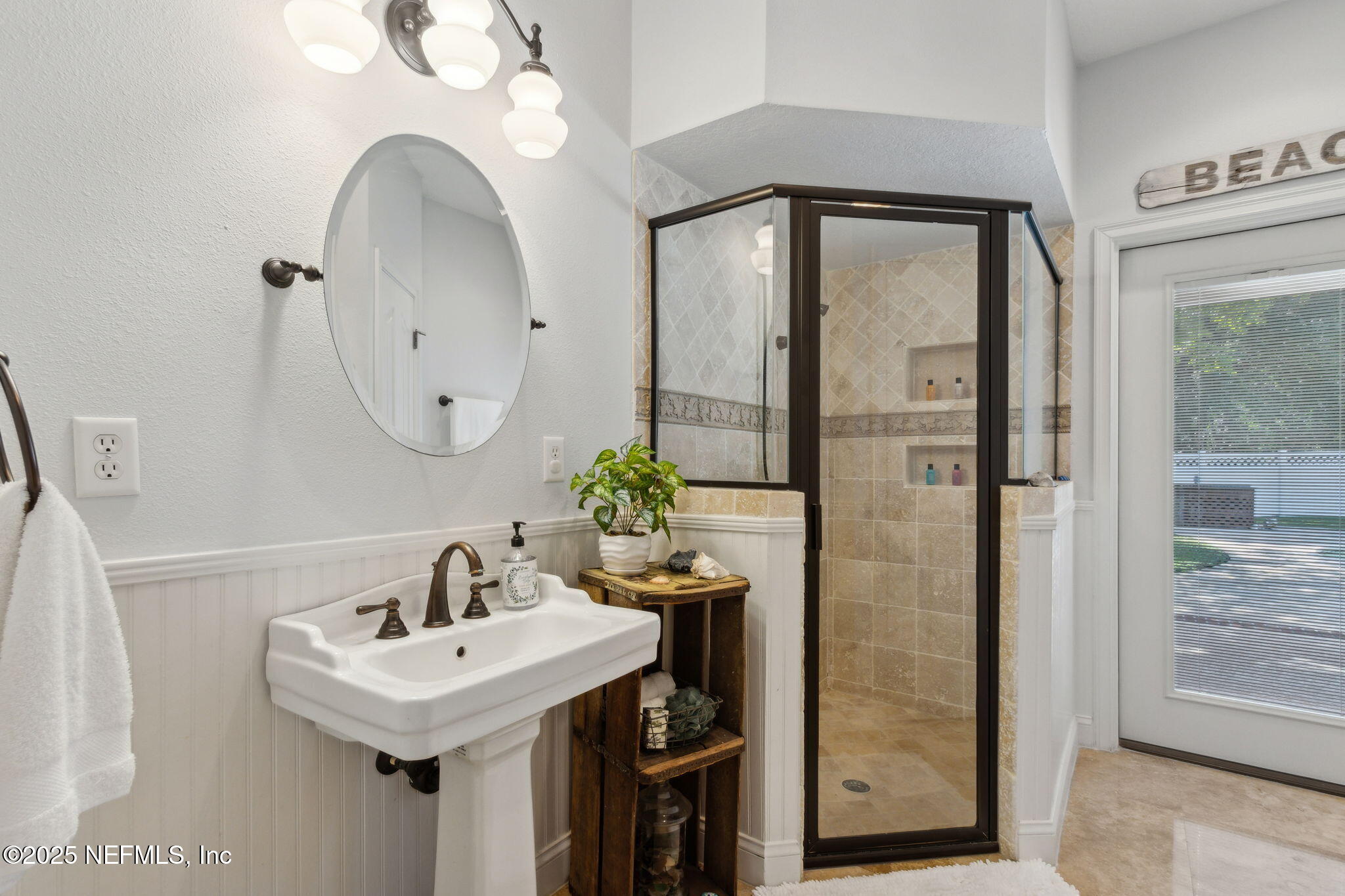87377 Raddin Road Yulee, FL 32097 - Photo 49 of 75 a bathroom with a sink a mirror and a shower