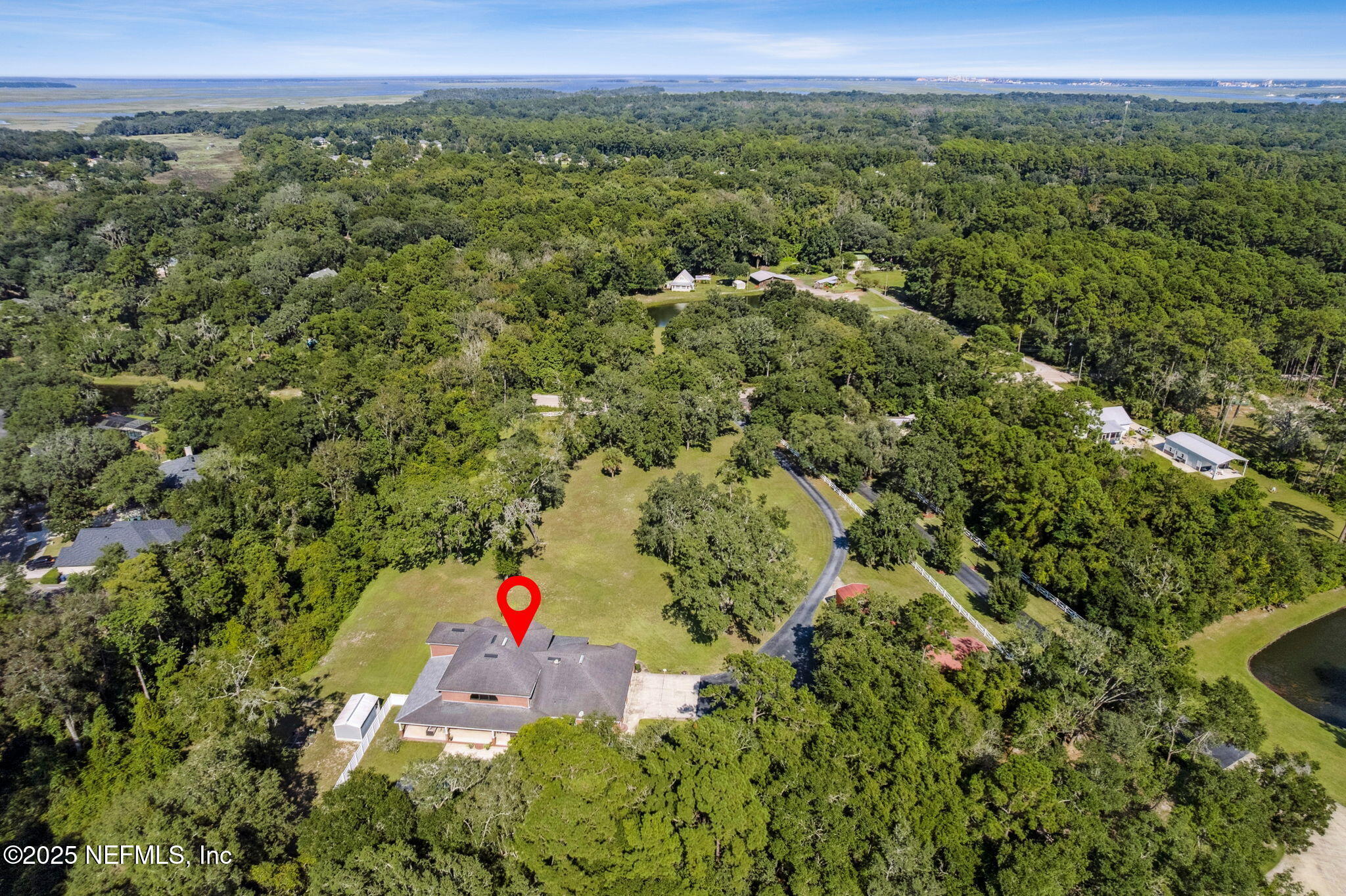 87377 Raddin Road Yulee, FL 32097 - Photo 74 of 75 an aerial view of residential houses with outdoor space and trees