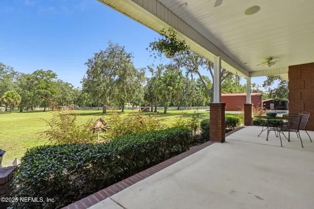 a living room with furniture chandelier and a rug