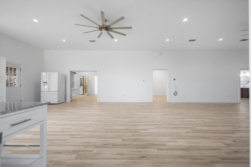6990 Pin Oak Road Big Sandy, TX 75755 - Photo 11 of 40 a view of a livingroom with a hardwood floor and a ceiling fan