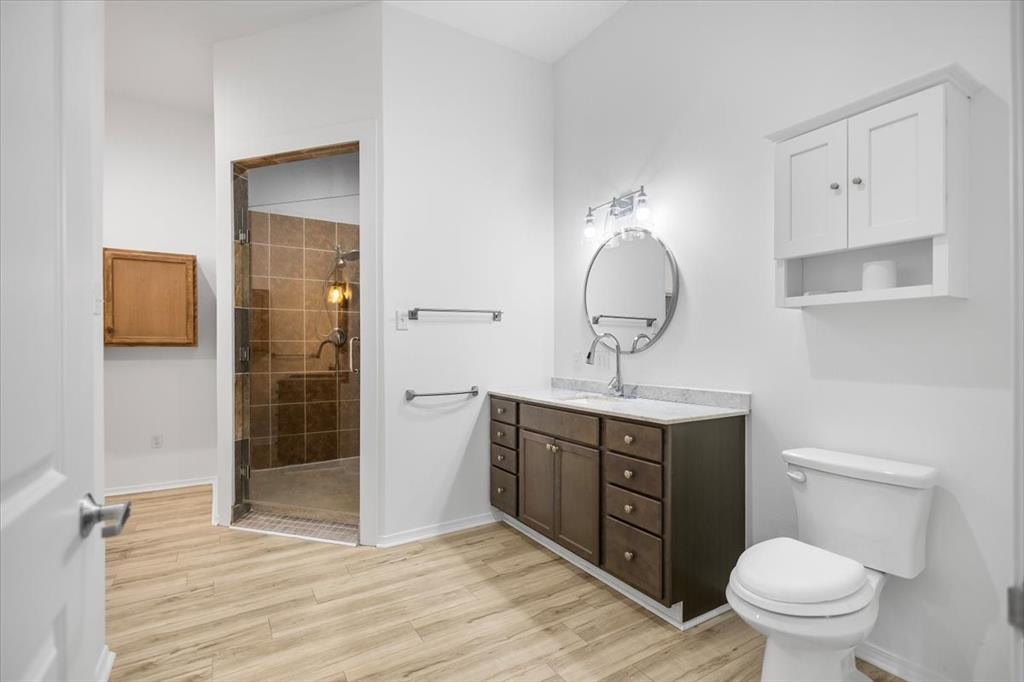 6990 Pin Oak Road Big Sandy, TX 75755 - Photo 12 of 40 a view of bathroom with a toilet sink and mirror