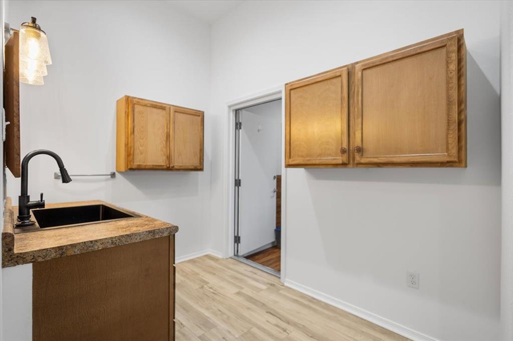 6990 Pin Oak Road Big Sandy, TX 75755 - Photo 15 of 40 a view of kitchen with wooden floor and cabinets