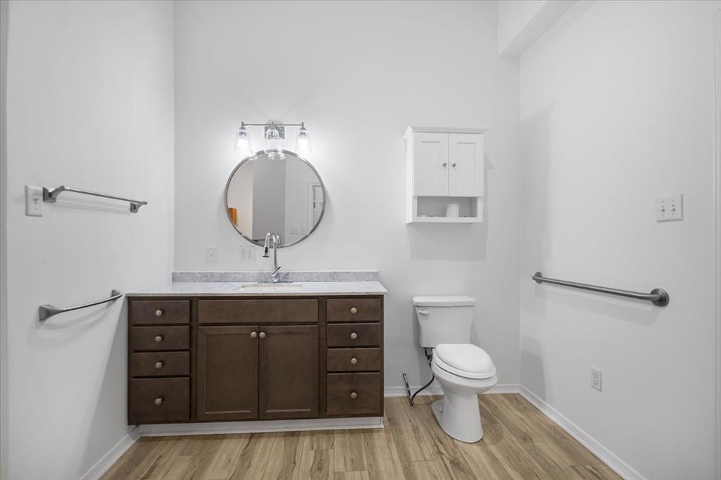6990 Pin Oak Road Big Sandy, TX 75755 - Photo 16 of 40 a bathroom with a toilet a sink and mirror