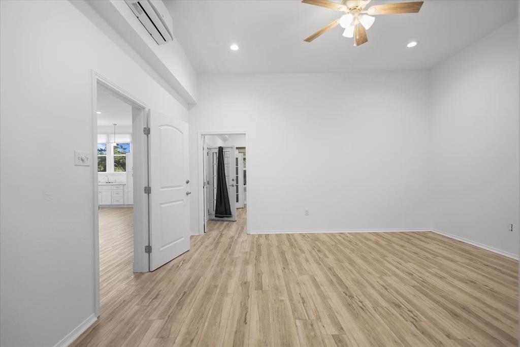 6990 Pin Oak Road Big Sandy, TX 75755 - Photo 18 of 40 wooden floor in an empty room with a window