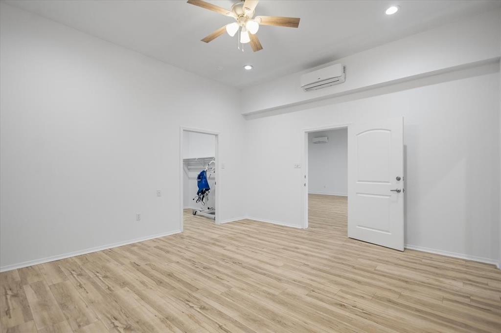 6990 Pin Oak Road Big Sandy, TX 75755 - Photo 20 of 40 a view of empty room with wooden floor and ceiling fan