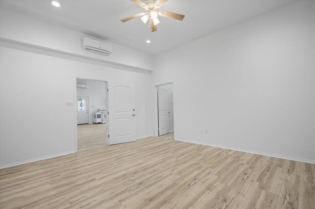 6990 Pin Oak Road Big Sandy, TX 75755 - Photo 21 of 40 a view of a room with wooden floor and a ceiling fan