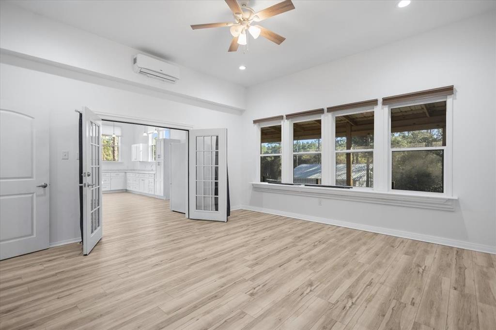 6990 Pin Oak Road Big Sandy, TX 75755 - Photo 24 of 40 a view of an empty room with wooden floor and a window