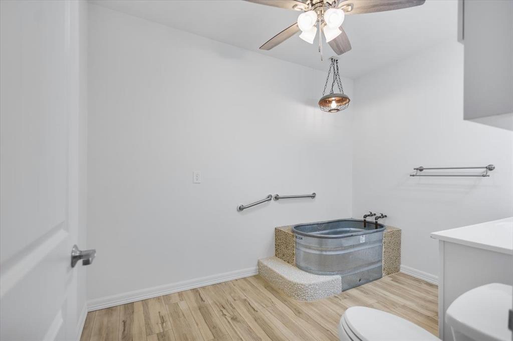 6990 Pin Oak Road Big Sandy, TX 75755 - Photo 25 of 40 a bathroom with a toilet and a sink