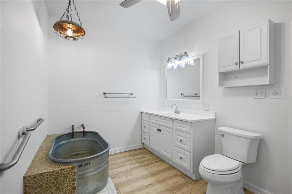 6990 Pin Oak Road Big Sandy, TX 75755 - Photo 26 of 40 a bathroom with a sink a toilet and a mirror
