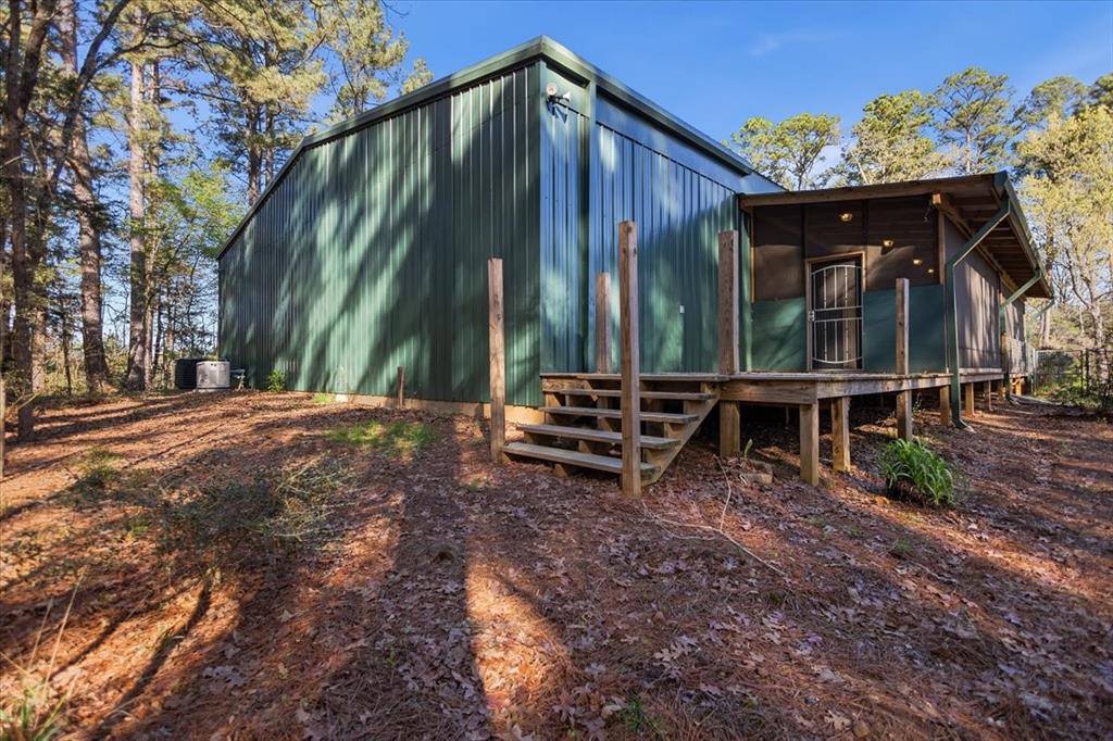 6990 Pin Oak Road Big Sandy, TX 75755 - Photo 33 of 40 a backyard of a house with barbeque oven table and chairs