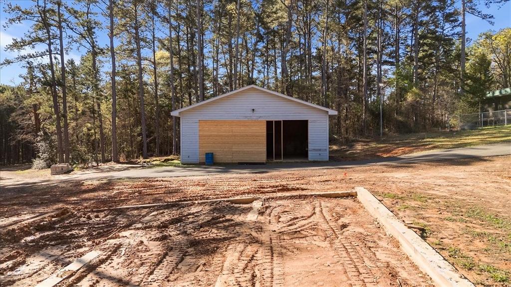 6990 Pin Oak Road Big Sandy, TX 75755 - Photo 35 of 40 a house with trees in front of it
