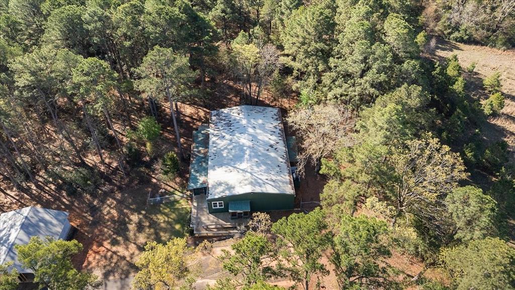 6990 Pin Oak Road Big Sandy, TX 75755 - Photo 40 of 40 a backyard of a building with large trees