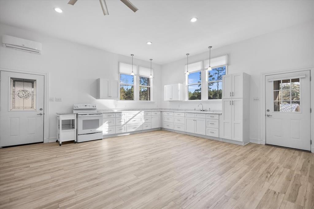 6990 Pin Oak Road Big Sandy, TX 75755 - Photo 4 of 40 a view of a kitchen with furniture and wooden floor