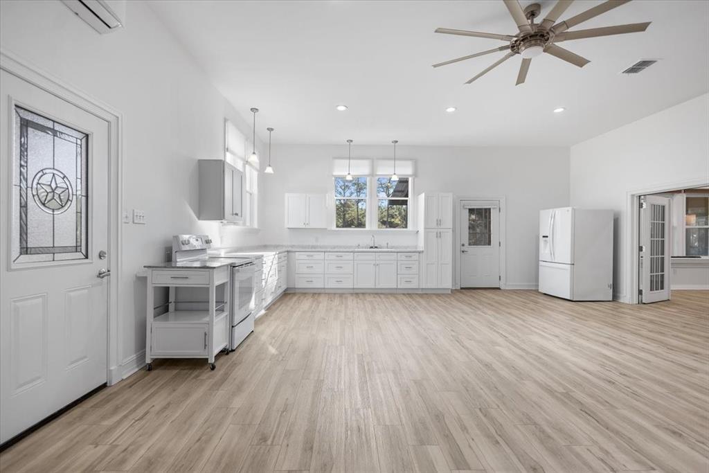 6990 Pin Oak Road Big Sandy, TX 75755 - Photo 5 of 40 a view of a kitchen with a sink cabinets and wooden floor