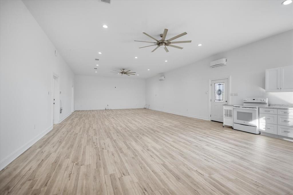 6990 Pin Oak Road Big Sandy, TX 75755 - Photo 6 of 40 wooden floor in an empty room with a window