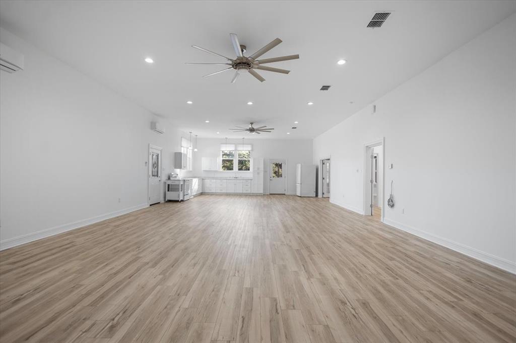6990 Pin Oak Road Big Sandy, TX 75755 - Photo 7 of 40 wooden floor in an empty room with a window