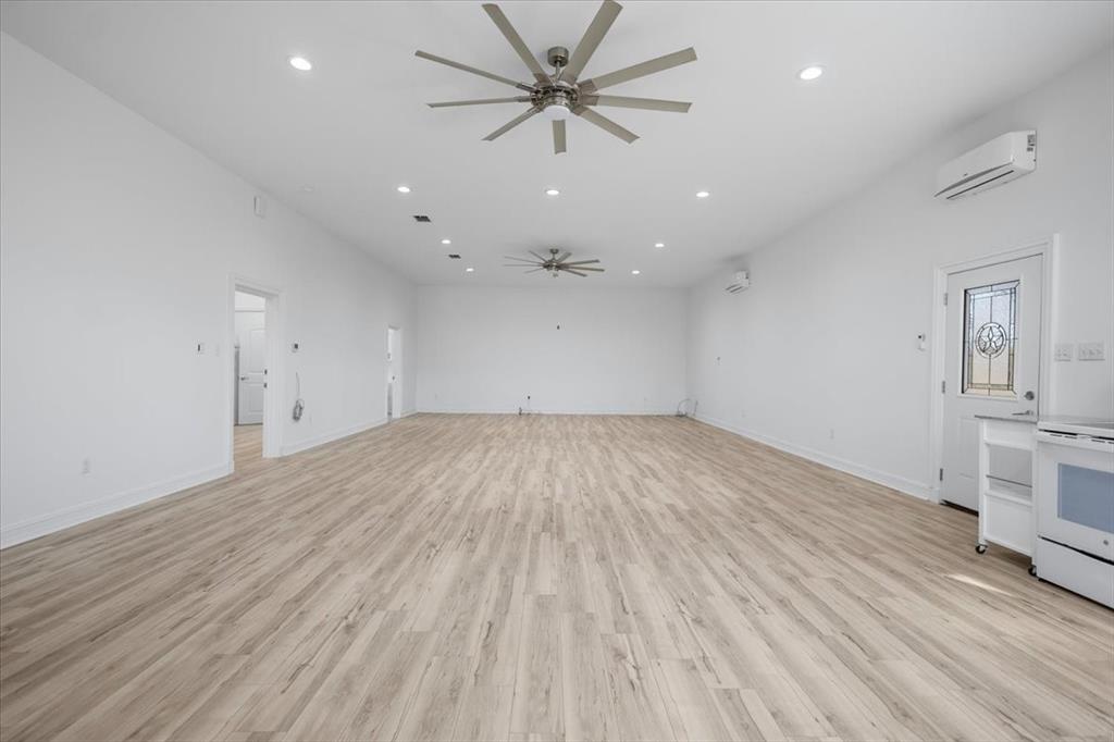 6990 Pin Oak Road Big Sandy, TX 75755 - Photo 8 of 40 wooden floor in an empty room with a window