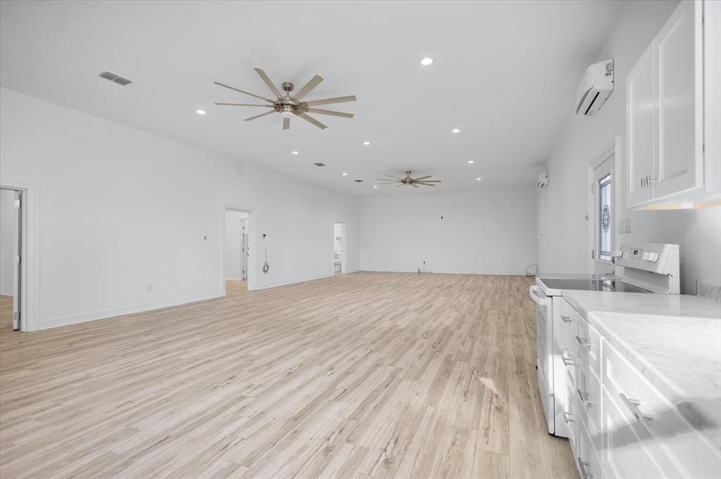 6990 Pin Oak Road Big Sandy, TX 75755 - Photo 9 of 40 a view of a kitchen with a sink and dishwasher with wooden floor
