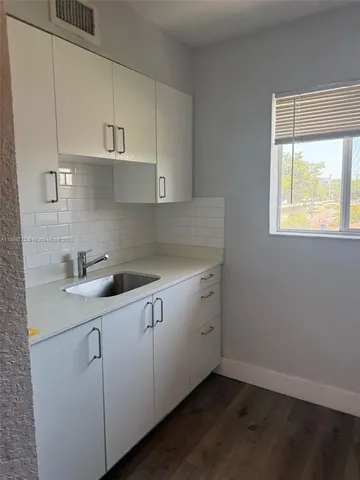 a kitchen with cabinets appliances and a sink