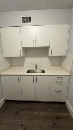 a view of cabinets and wooden floor