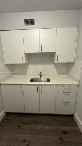 a view of cabinets and wooden floor
