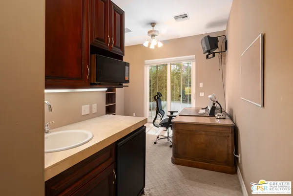 a kitchen with stainless steel appliances granite countertop a sink refrigerator and cabinets
