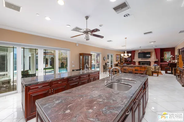 a large kitchen with a large counter top stainless steel appliances and cabinets