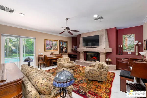 a living room with furniture a window and gym equipment