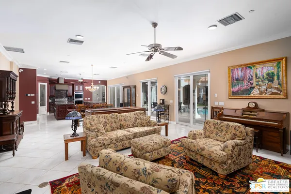 a view of a livingroom with furniture and a chandelier fan