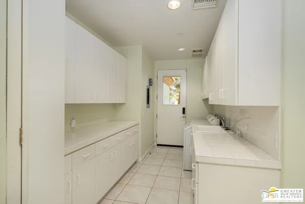 a bathroom with a granite countertop sink a mirror and a shower