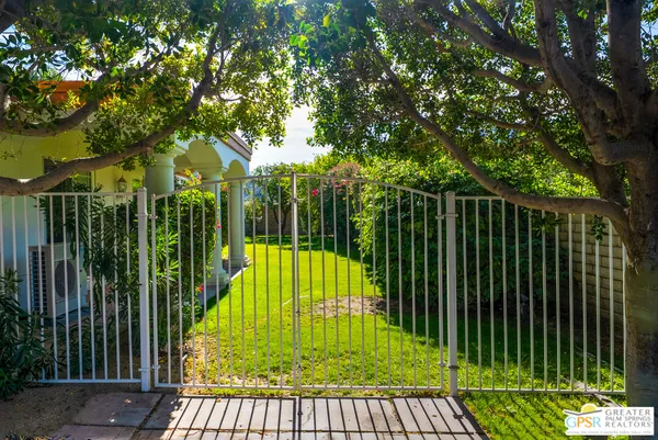 a view of a patio with a table chairs and a backyard
