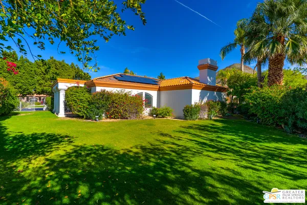 a front view of house with yard and outdoor seating