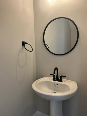 a bathroom with a sink and mirror