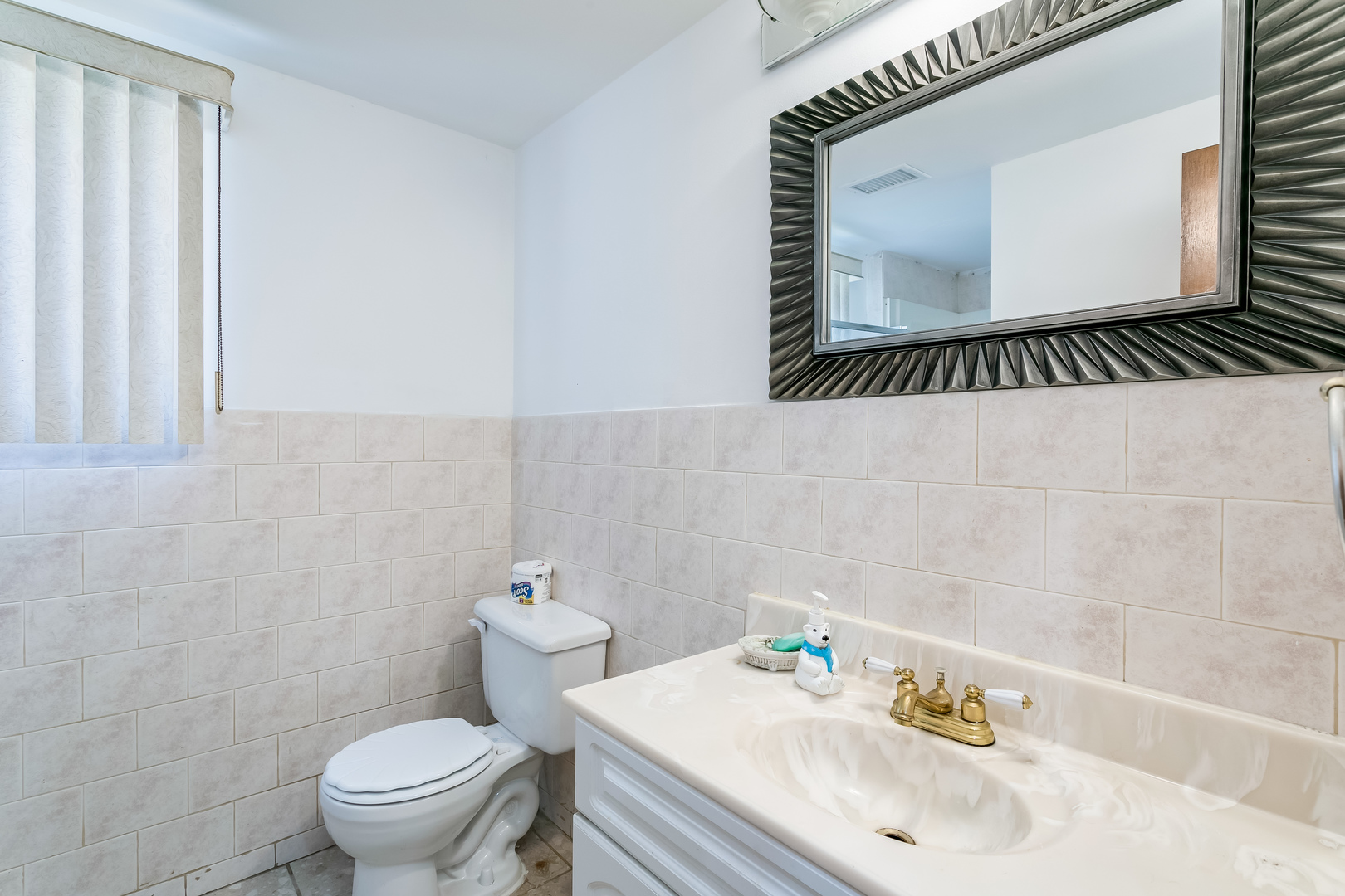 3729 Roth Terrace Skokie, IL 60076 - Photo 12 of 27 a bathroom with a sink mirror and toilet