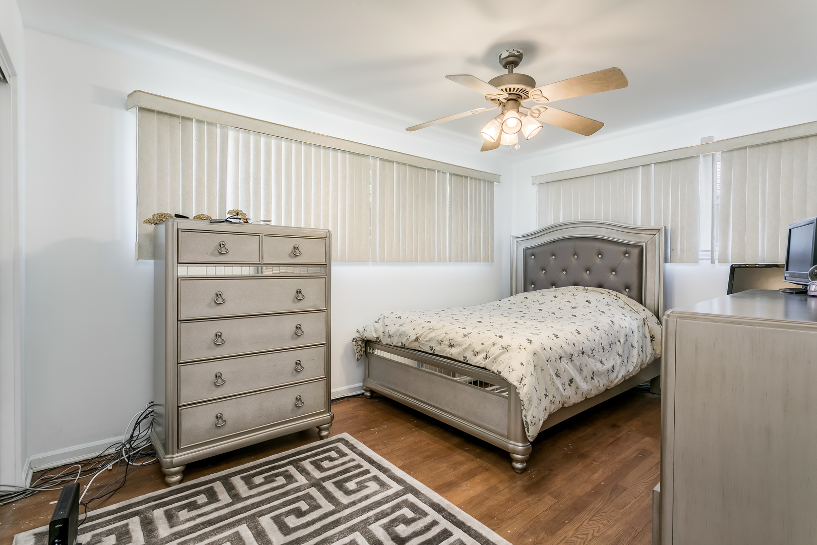 3729 Roth Terrace Skokie, IL 60076 - Photo 14 of 27 a bedroom with a large bed and ceiling fan