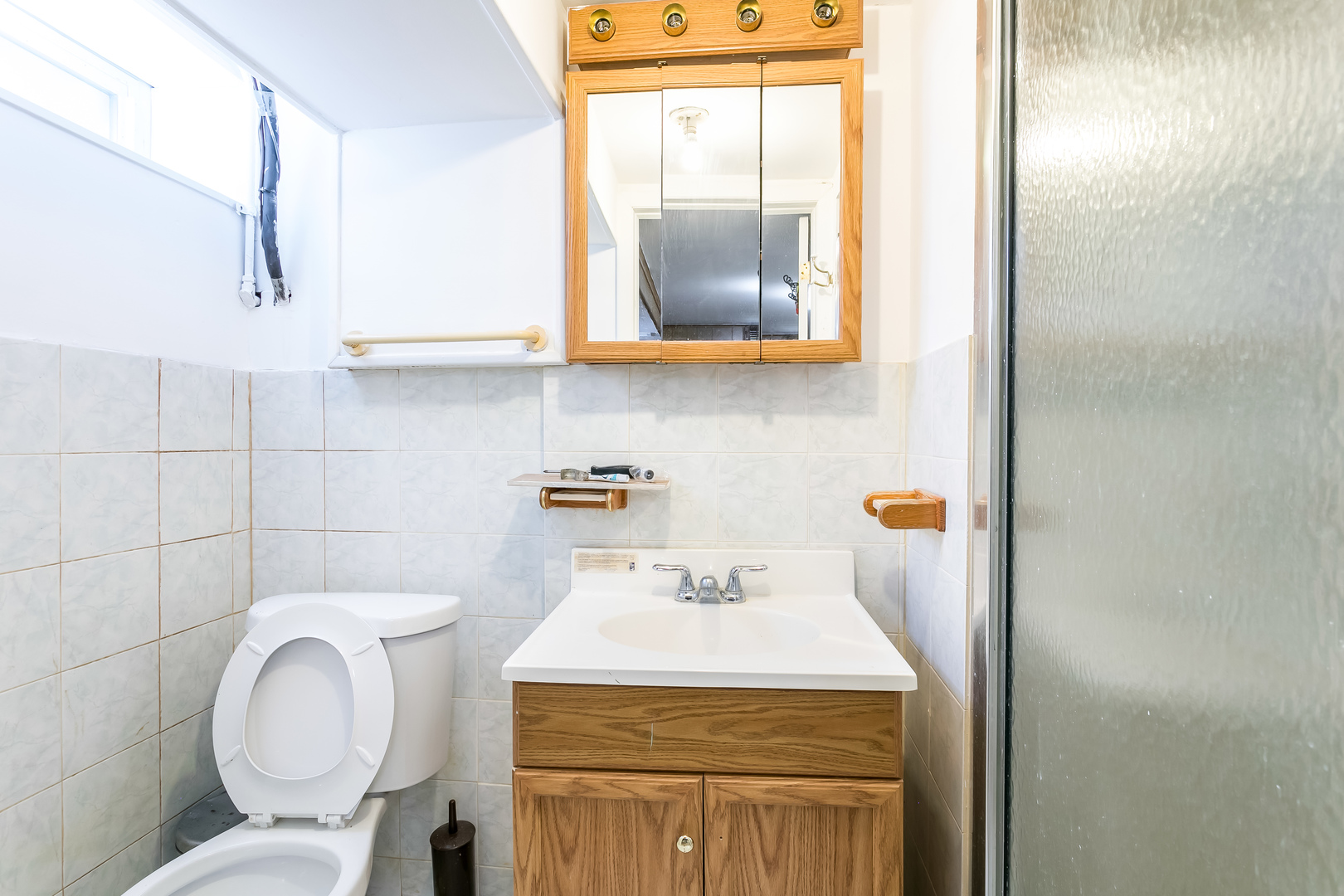 3729 Roth Terrace Skokie, IL 60076 - Photo 21 of 27 a bathroom with a toilet sink and mirror