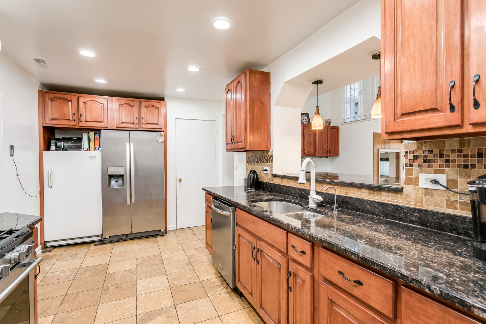 3729 Roth Terrace Skokie, IL 60076 - Photo 6 of 27 a large kitchen with stainless steel appliances granite countertop a refrigerator and a sink