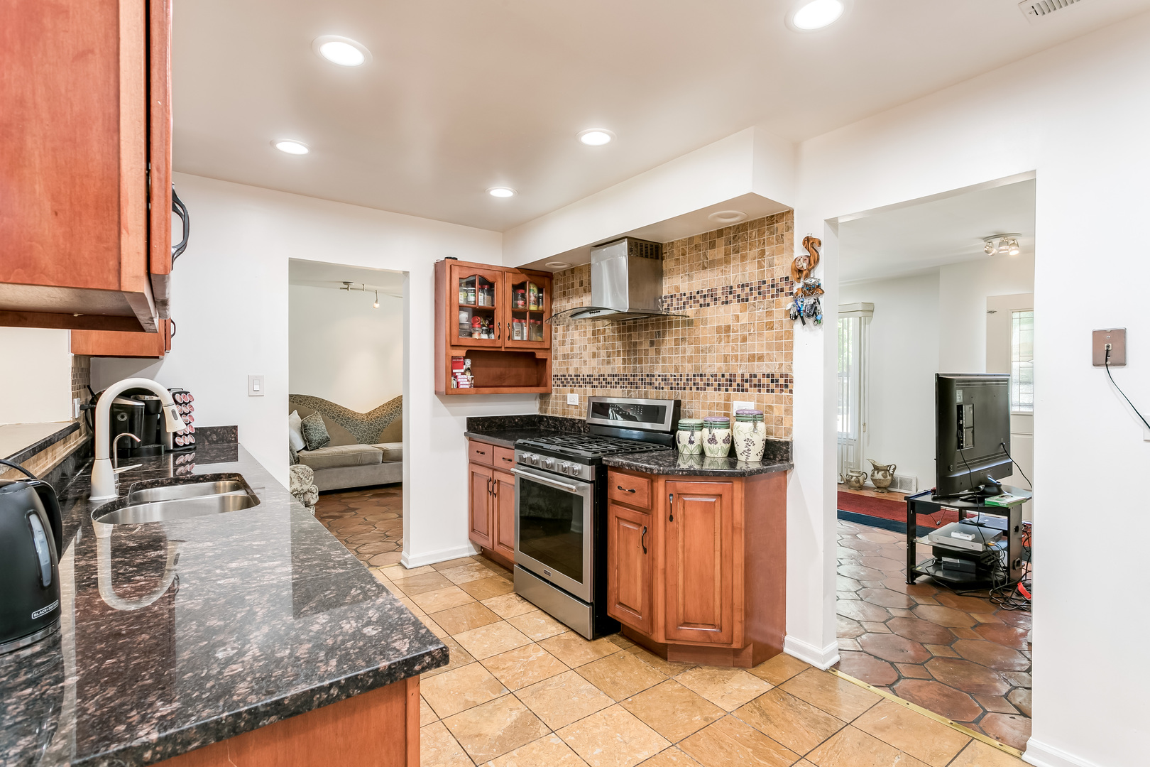 3729 Roth Terrace Skokie, IL 60076 - Photo 7 of 27 a kitchen with stainless steel appliances granite countertop a sink stove and refrigerator