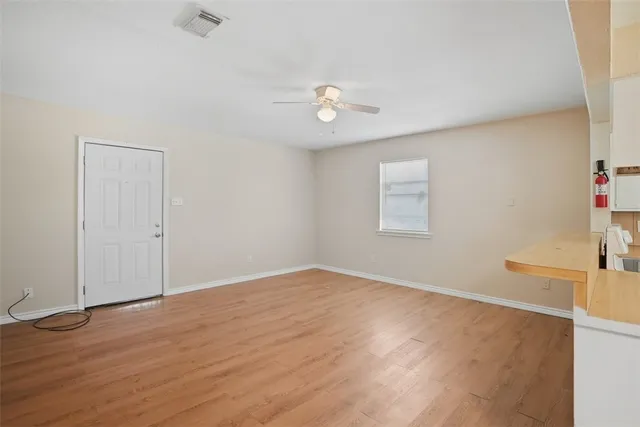 wooden floor in an empty room with a window