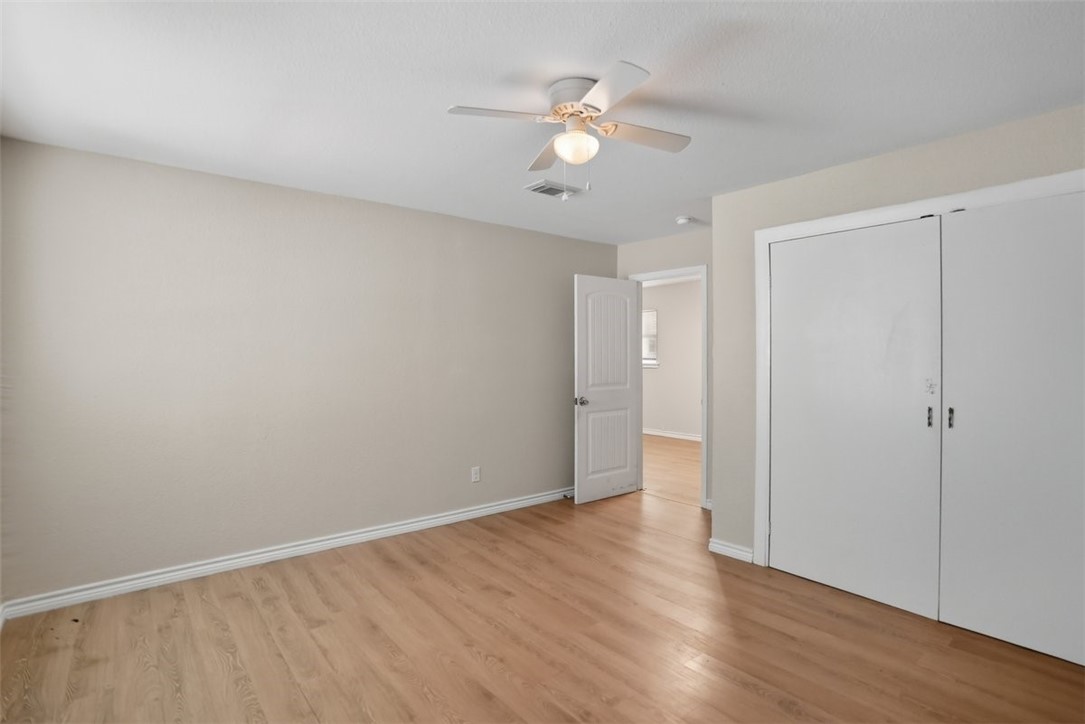 868 Gonzales Street, Unit 2 Robstown, TX 78380 - Photo 12 of 16 a view of an empty room with wooden floor