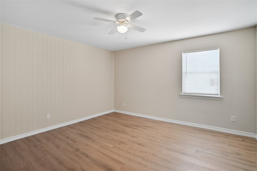 868 Gonzales Street, Unit 2 Robstown, TX 78380 - Photo 13 of 16 a view of a room with wooden floor and a ceiling fan