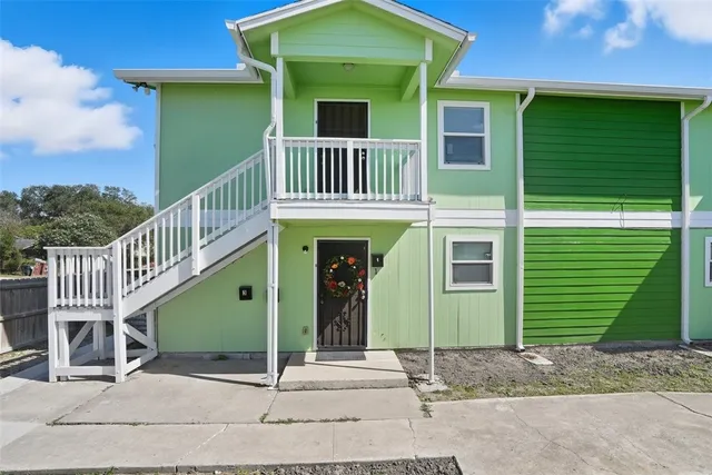 a front view of a house with a green yard