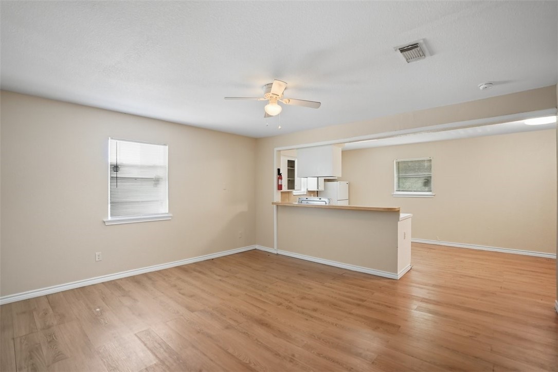 868 Gonzales Street, Unit 2 Robstown, TX 78380 - Photo 6 of 16 a view of empty room with wooden floor and fan