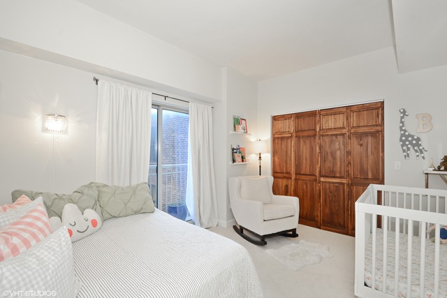 720 West Randolph Street, Unit 808 Chicago, IL 60661 - Photo 11 of 15 a bedroom with a bed and a chair