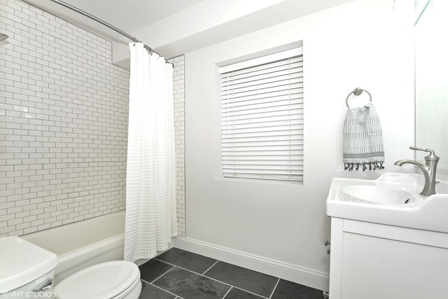 720 West Randolph Street, Unit 808 Chicago, IL 60661 - Photo 12 of 15 a bathroom with a sink toilet and shower